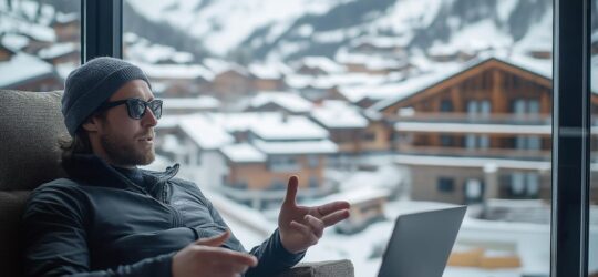 man working remotely laptop with scenic mountainous backdrop 540x250